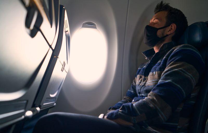 passenger with mask sleeping