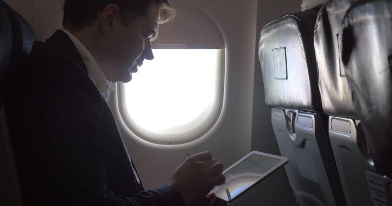airplane passenger with tablet