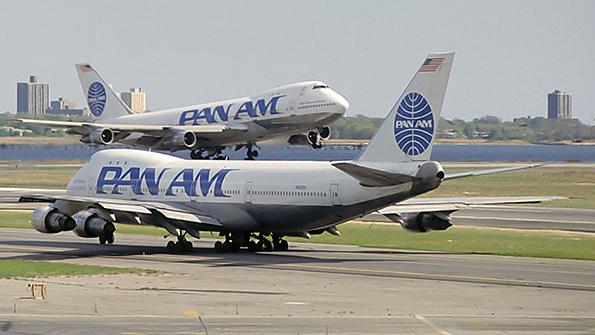 two 747-400s taxiing on runways