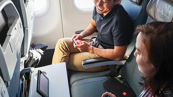 Airplane passengers playing video games