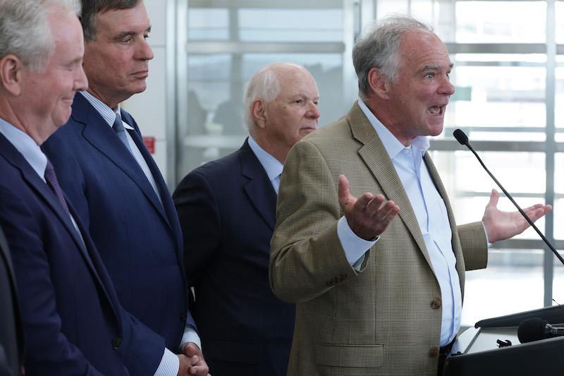 U.S. Sen. Tim Kaine (D-VA) speaks as (L-R) Sen. Chris Van Hollen (D-MD), Sen. Mark Warner (D-VA), and Sen. Ben Cardin (D-MD) listen during a news conference at Ronald Reagan Washington National Airport 