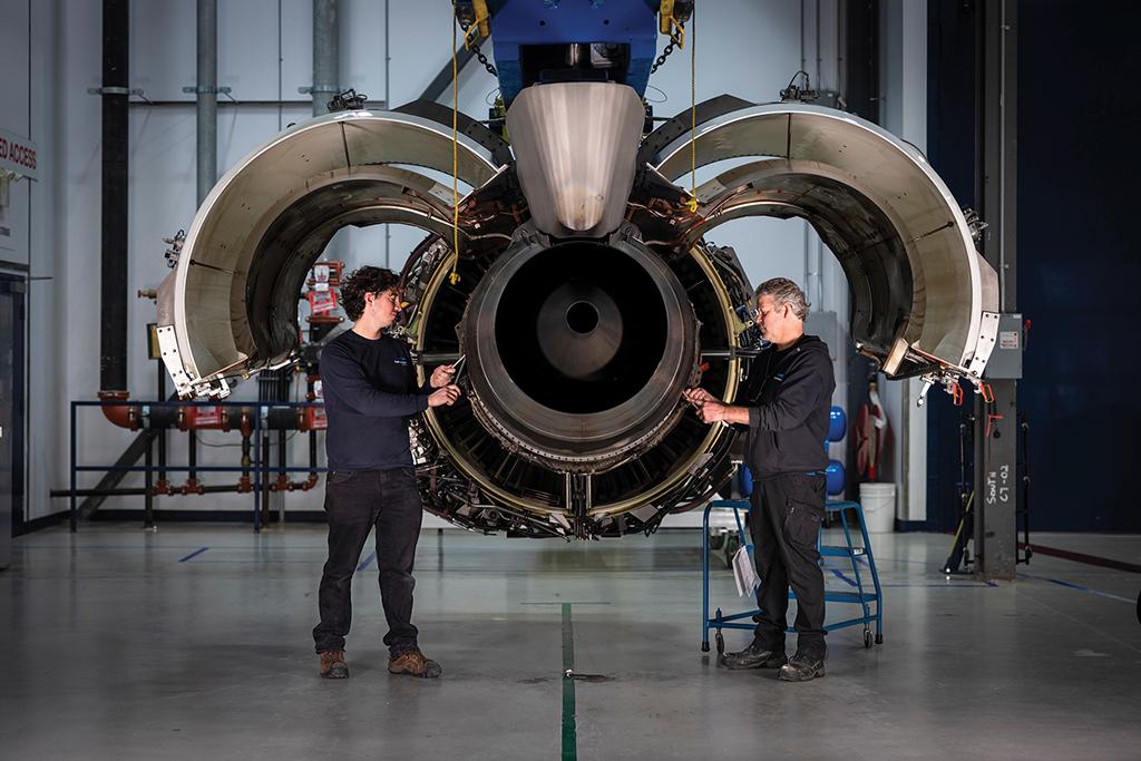 aircraft technicians working on engine