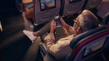 Man accesses Wi-Fi on mobile device onboard aircraft
