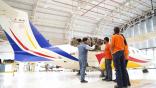 Students with an aircraft in GMR School of Aviation's hangar